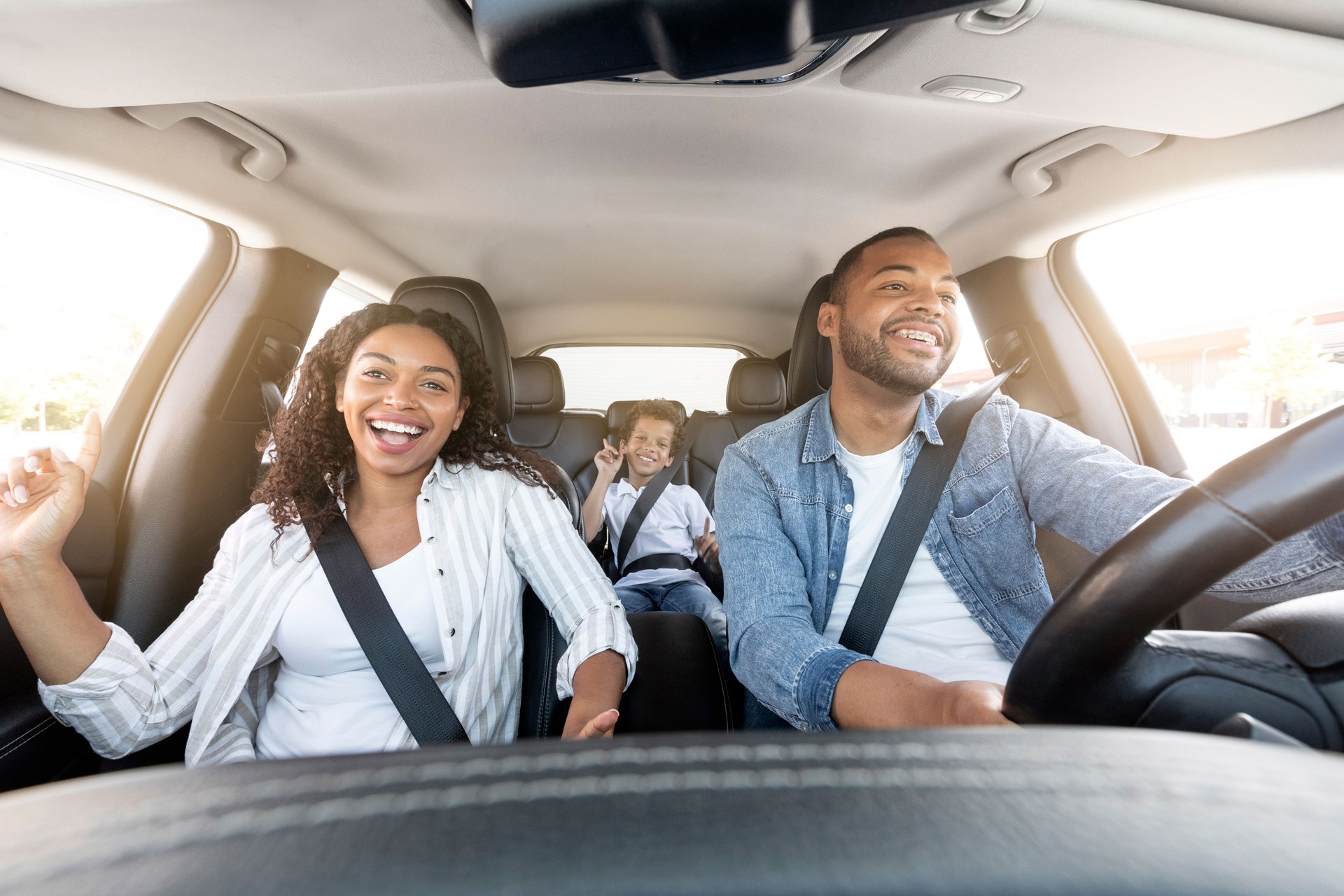 Happy african american family riding car, traveling by automobile